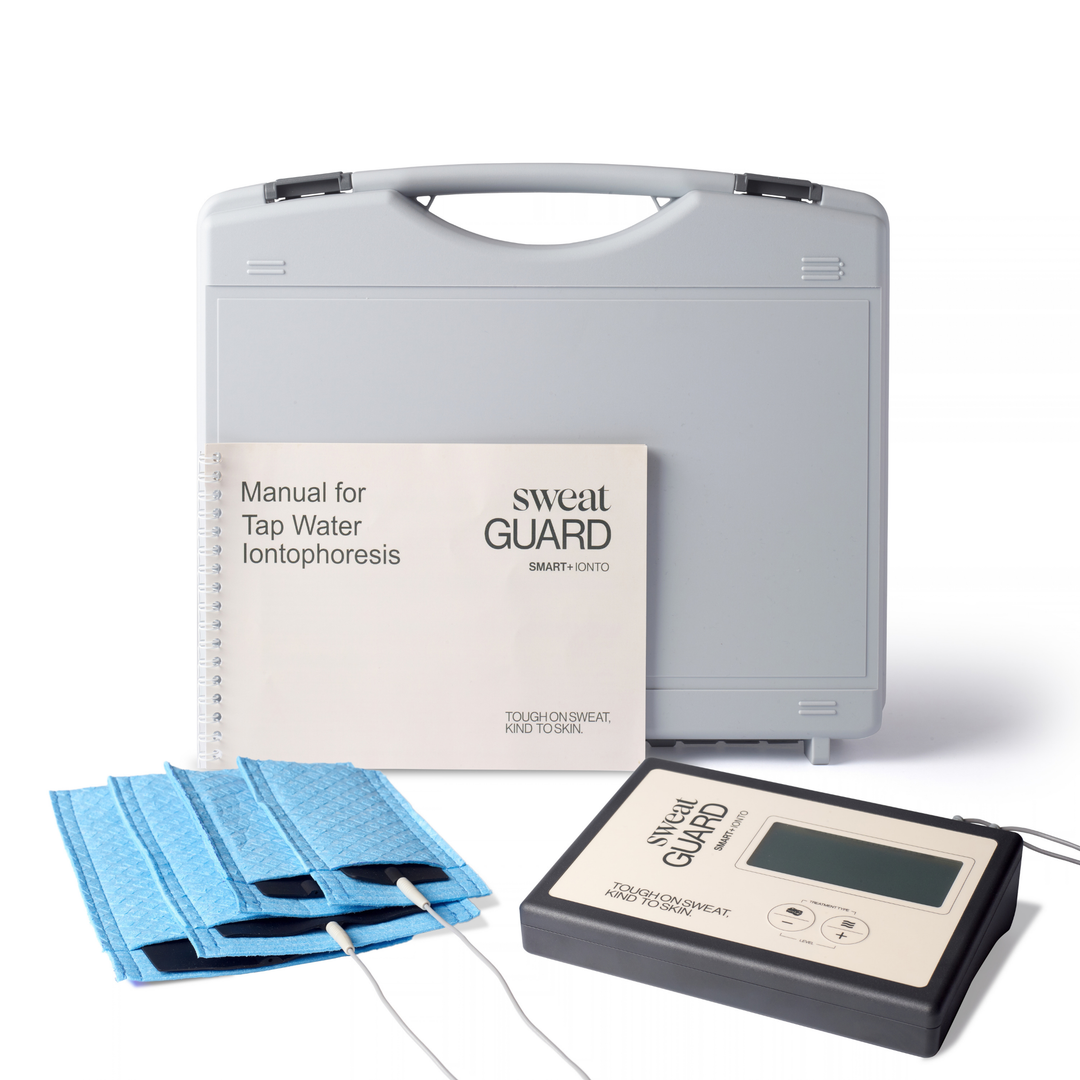 Tap Water Iontophoresis device kit including a gray carrying case, a beige and black electronic controller, blue electrode pads, and a printed user manual on a white background.